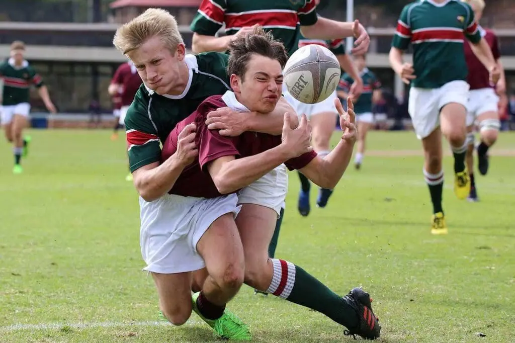 A rugby tackle in action, young people sports