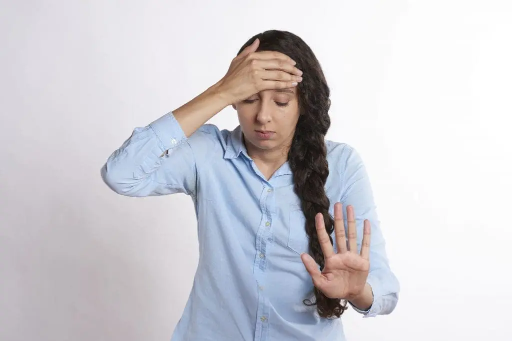 A woman holding her head in pain