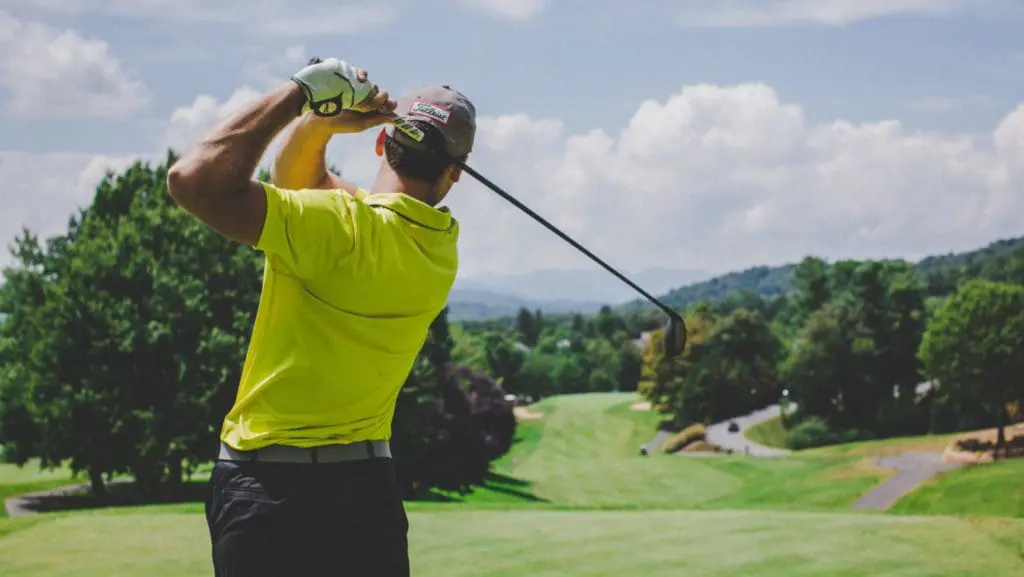 A golf course with player and fairway