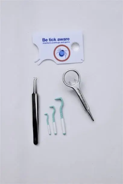 A selection of tick removal tools including twisters, cards and tweezers