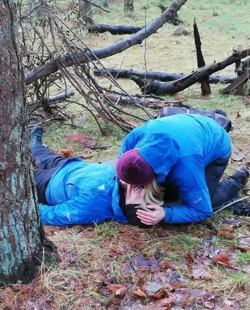 Woman checking breathing in an outdoor setting OFA