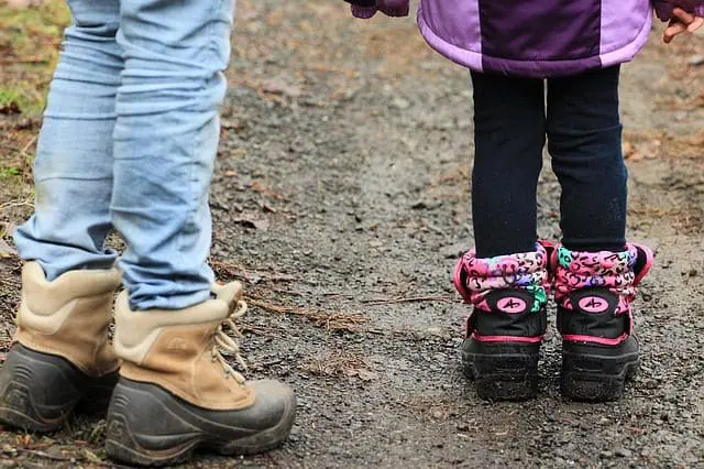two people with trousers tucked into socks