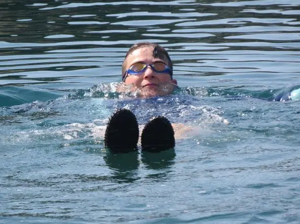 A person floating on their back in open water