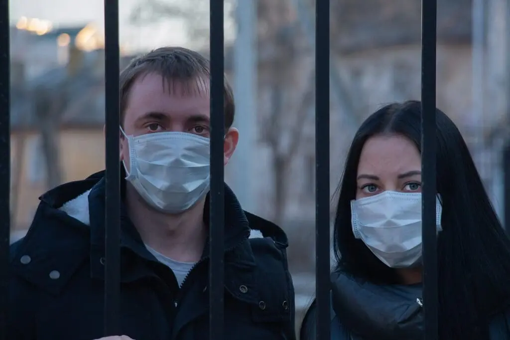 A couple wearing surgical masks