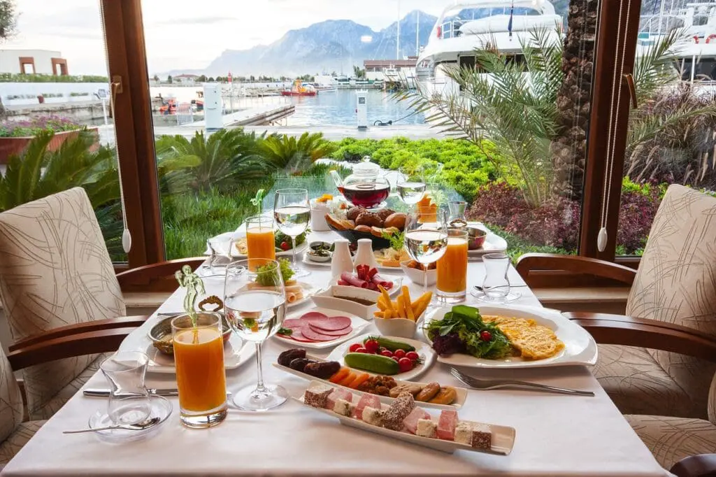 A breakfast table setting with a sea view