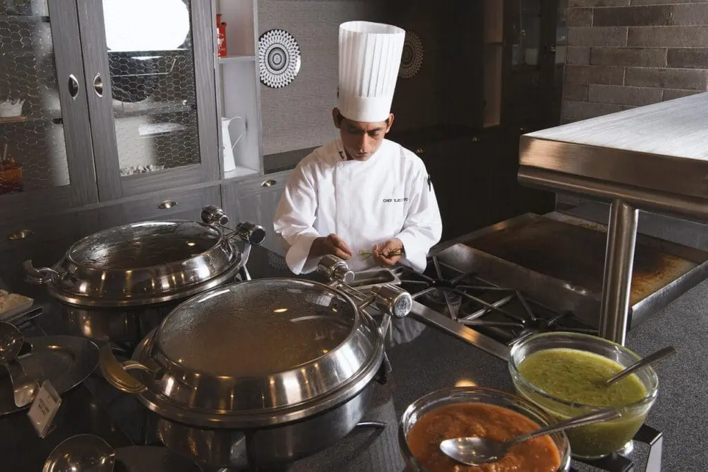 Chef with large pans of liquids