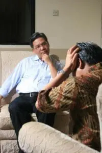 A counselling session with 2 men