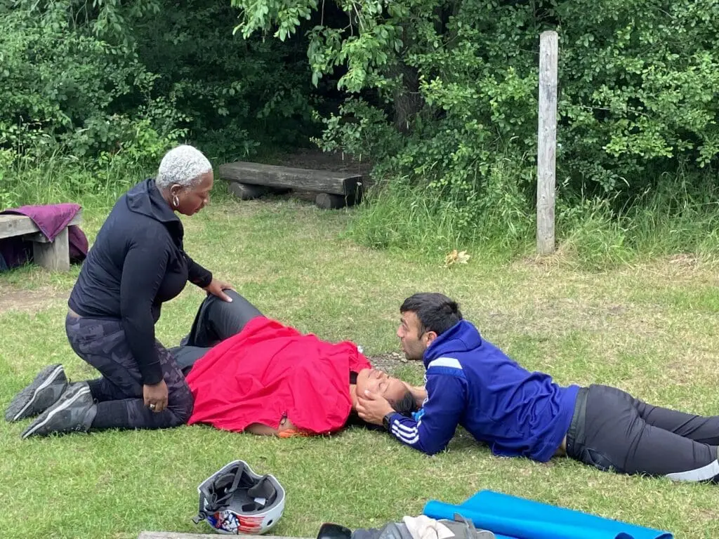 A Backbone CIC group practicing a 2 person rescue on an Outdoor First Aid course