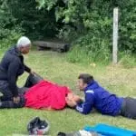 A Backbone CIC group practicing a 2 person rescue on an Outdoor First Aid course