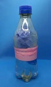 A severed digit wrapped in surgical gloves inside a plastic bottle with water.