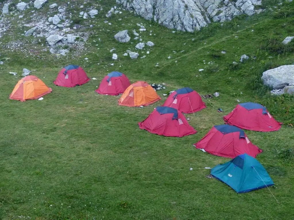 A row of tents on a mountain campsite