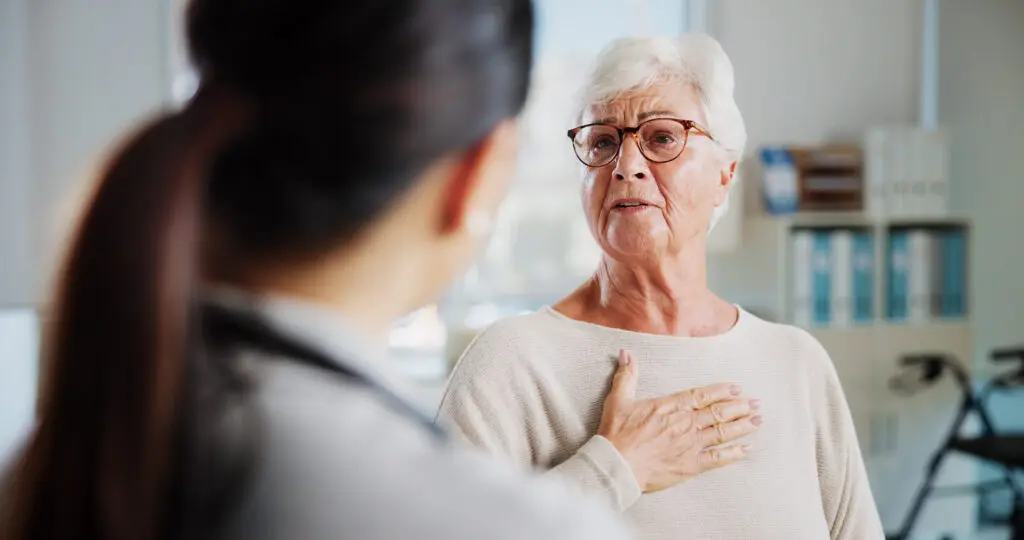 An older woman talking to another younger woman