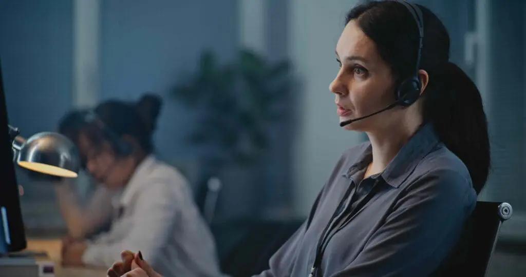 A woman in a call centre with headphones