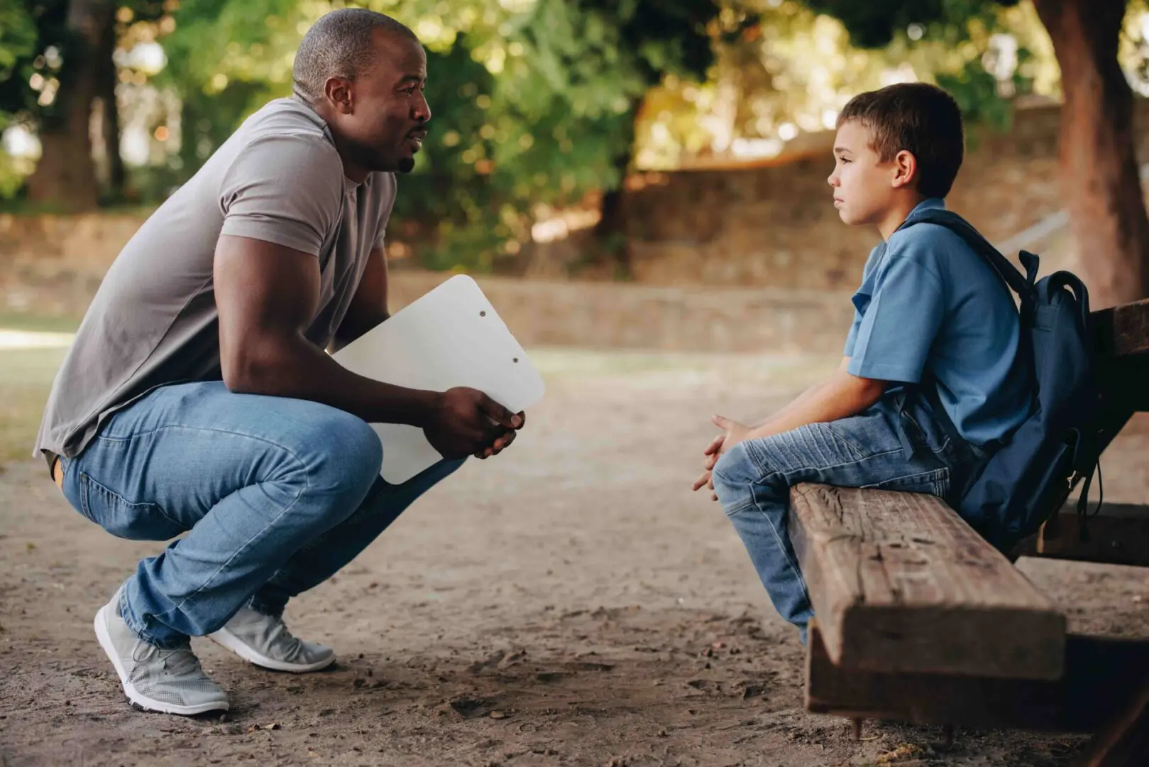 A teacher reassuring a child in the playground