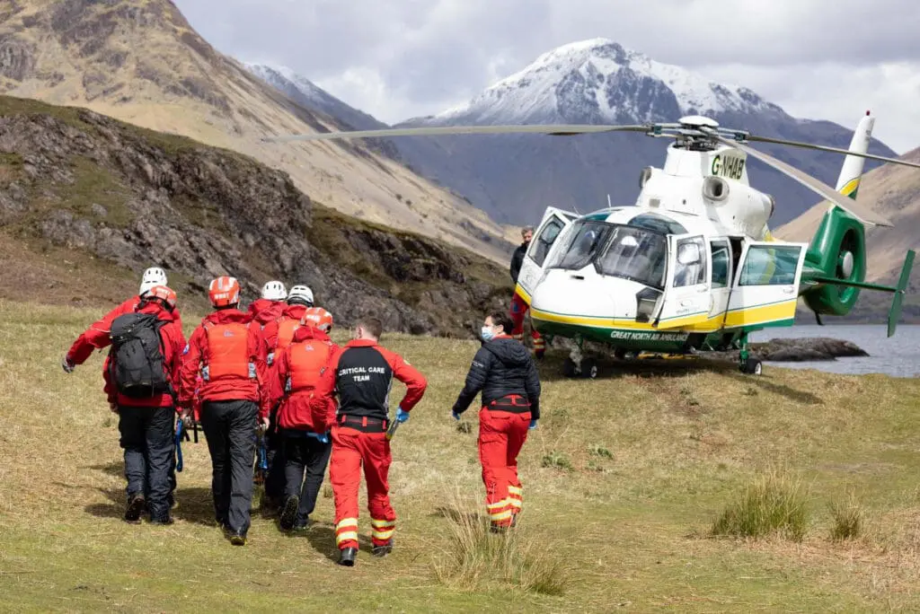 A mountain rescue team and helicopter.