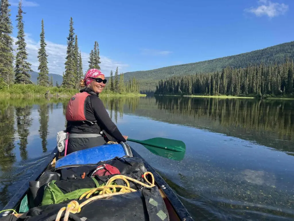 A woman in an expedition kayak outdoors