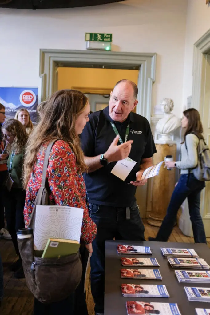 Cory Jones of First Aid Training Co-operative discussing mental health first aid training with a delegate at the RS Explore 20205 conference.