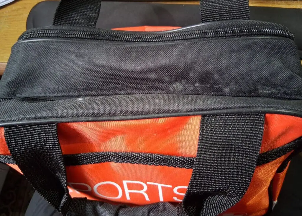 The top of a first aid kit with mould on the surface.