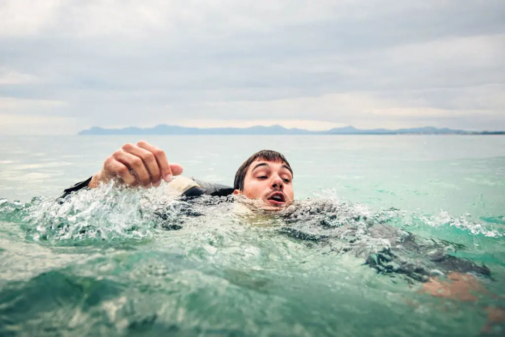 Man struggling in the water. Maybe drowning. How to help a drowning casualty with CPR