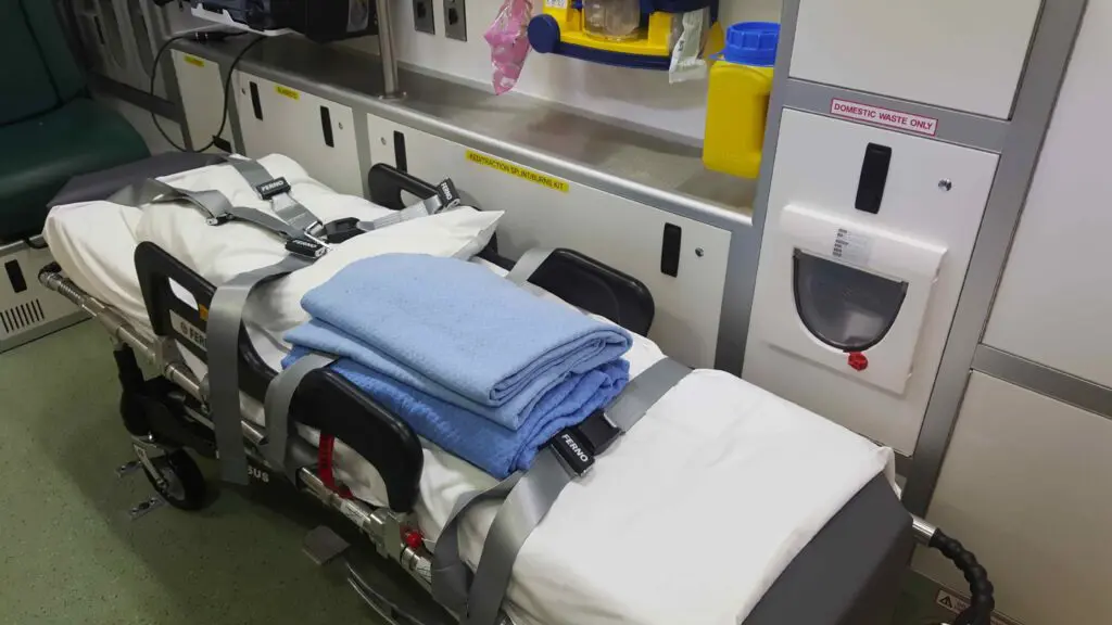 The inside of an ambulance with the trolley ready for a patient.